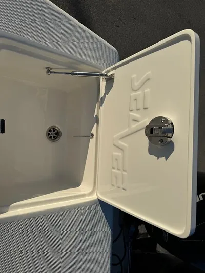  Yacht Photos Pics 2023 SeaVee 290B boat compartment with open lid, showcasing interior and drain.