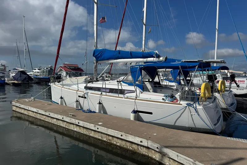Sea Ranch II Yacht Photos Pics 2018 Jeanneau Sun Odyssey 389 sailboat docked at marina under blue sky.