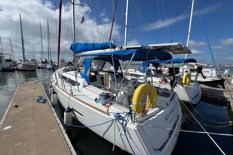 Sea Ranch II Yacht Photos Pics 2018 Jeanneau Sun Odyssey 389 sailboat docked at marina under blue sky.