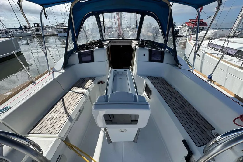 Sea Ranch II Yacht Photos Pics 2018 Jeanneau Sun Odyssey 389 cockpit with blue canopy, docked at marina.
