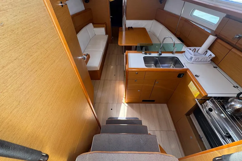 Sea Ranch II Yacht Photos Pics 2018 Jeanneau Sun Odyssey 389 interior with kitchen, seating, and wooden finishes.