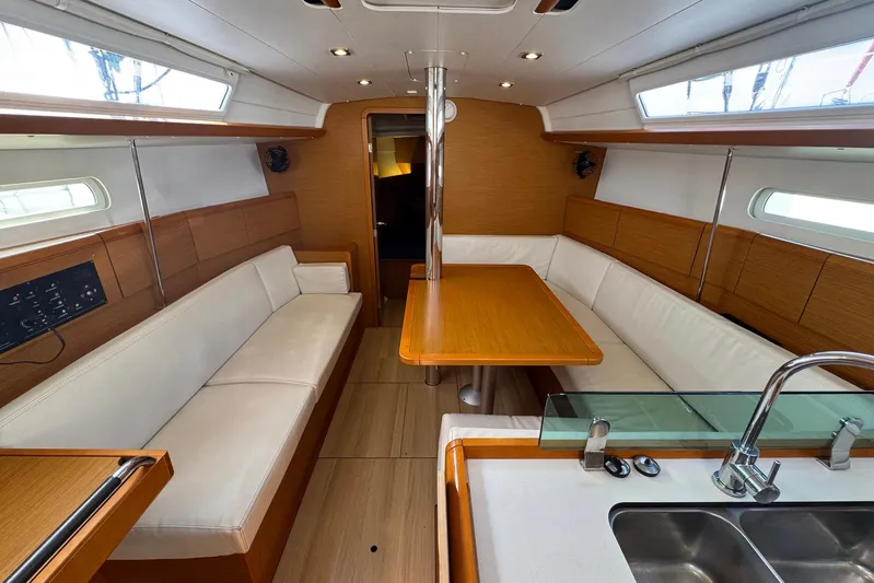 Sea Ranch II Yacht Photos Pics Interior of 2018 Jeanneau Sun Odyssey 389 yacht with modern seating and dining area.