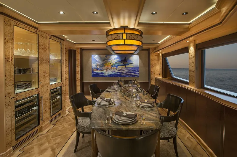 Cazador Yacht Photos Pics Luxurious dining area on 2019 Nordlund Expedition Yachtfisher with ocean view and elegant decor.