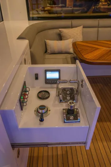 Cazador Yacht Photos Pics Control panel of a 2019 Nordlund Expedition Yachtfisher with seating area in the background.