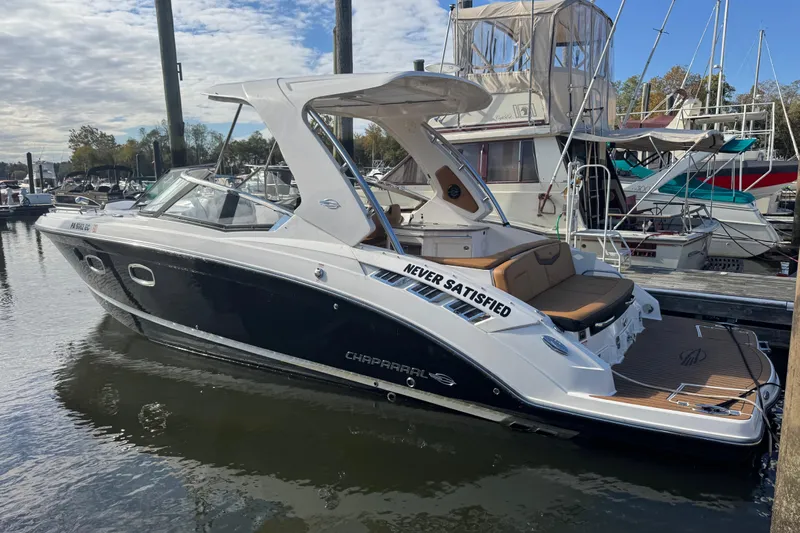  Yacht Photos Pics 2023 Chaparral 347 SSX boat docked at a marina under a partly cloudy sky.