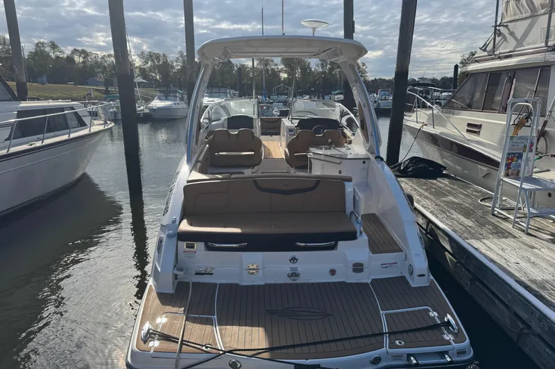  Yacht Photos Pics 2023 Chaparral 347 SSX boat docked at marina, showcasing spacious seating and sleek design.