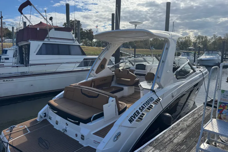  Yacht Photos Pics 2023 Chaparral 347 SSX luxury boat docked at marina under cloudy sky.