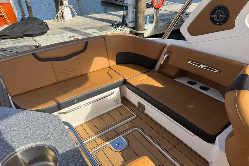  Yacht Photos Pics 2023 Chaparral 347 SSX boat interior with tan leather seating and wood flooring.