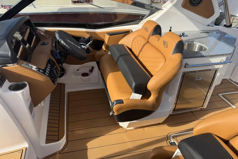  Yacht Photos Pics 2023 Chaparral 347 SSX boat interior with tan leather seats and modern dashboard.