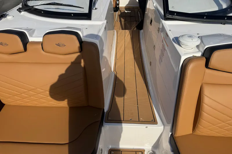  Yacht Photos Pics 2023 Chaparral 347 SSX boat interior with tan leather seats and wood flooring.