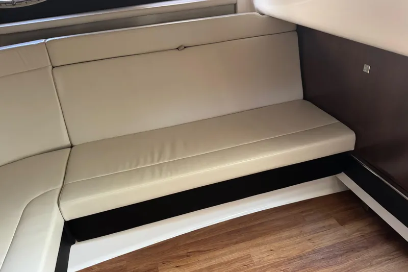  Yacht Photos Pics 2023 Chaparral 347 SSX interior with beige leather seating and wooden flooring.