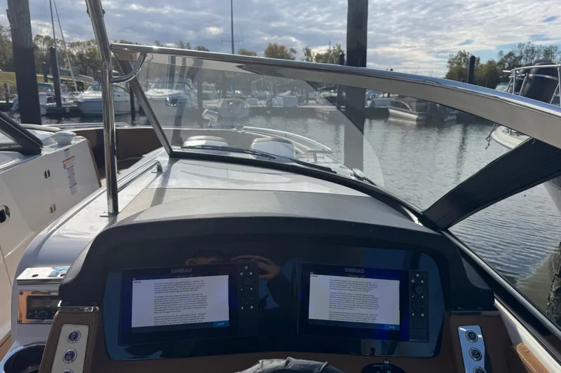  Yacht Photos Pics 2023 Chaparral 347 SSX boat dashboard with dual Simrad displays at marina.