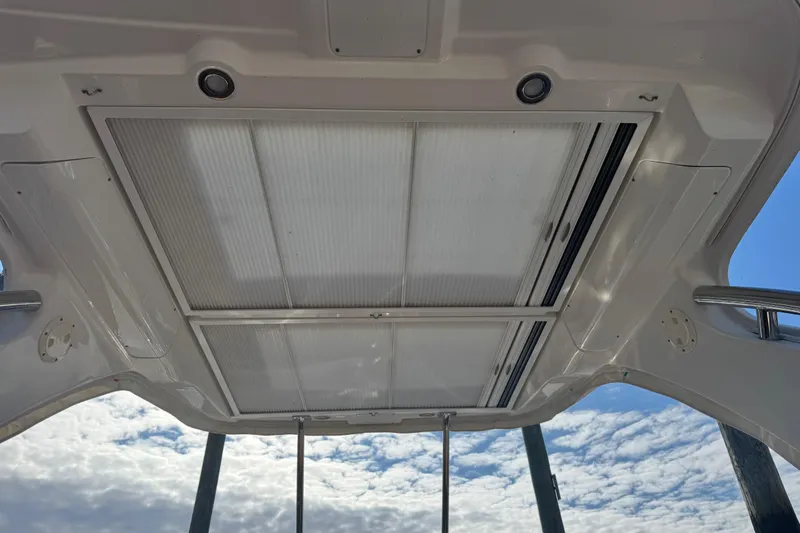  Yacht Photos Pics 2023 Chaparral 347 SSX boat roof with retractable sunroof under a cloudy sky.