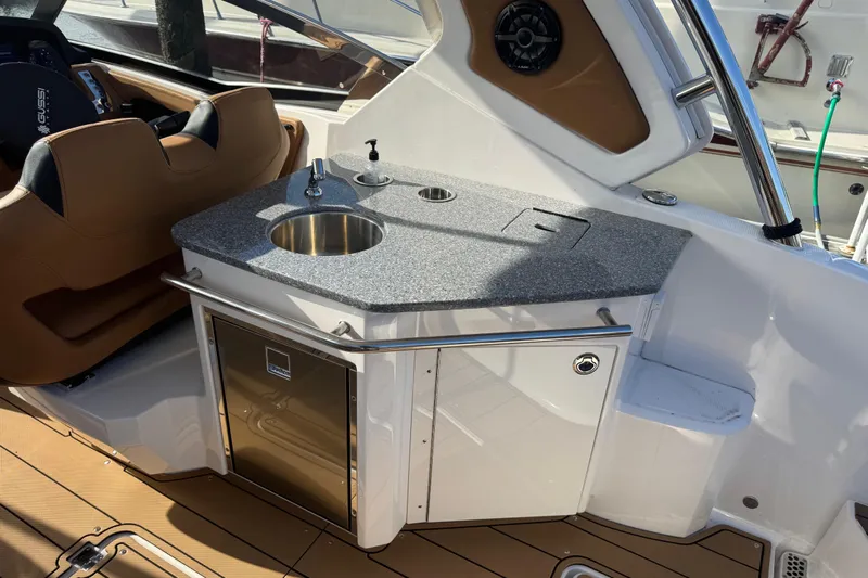  Yacht Photos Pics 2023 Chaparral 347 SSX boat interior with sink and seating area.