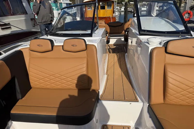  Yacht Photos Pics 2023 Chaparral 347 SSX boat interior with tan leather seating and wooden flooring.