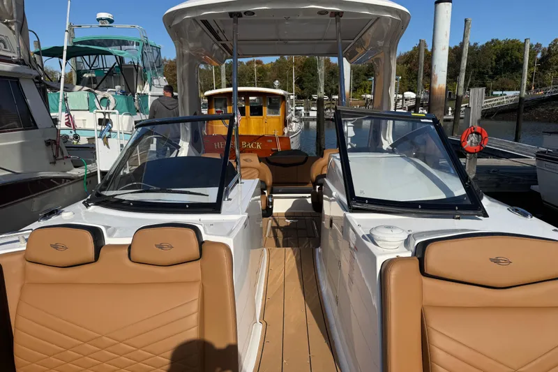  Yacht Photos Pics 2023 Chaparral 347 SSX boat docked, featuring tan leather seats and sleek design.