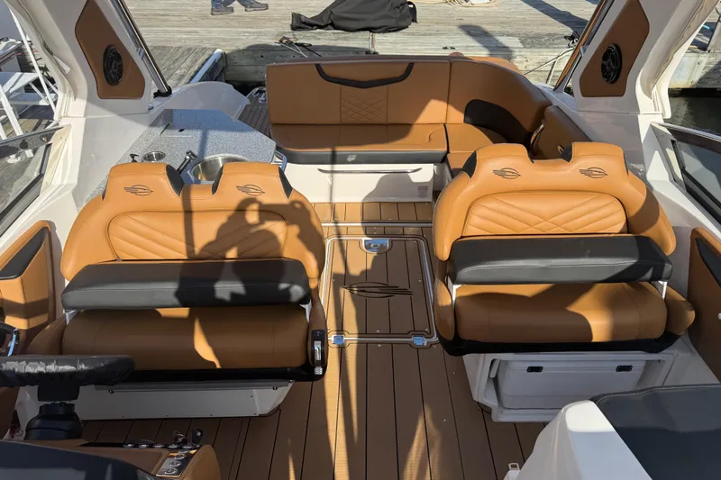  Yacht Photos Pics 2023 Chaparral 347 SSX boat interior with tan leather seating and wood flooring.