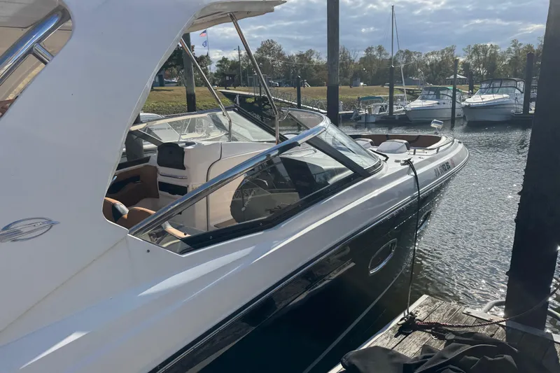  Yacht Photos Pics 2023 Chaparral 347 SSX boat docked at marina under cloudy sky.