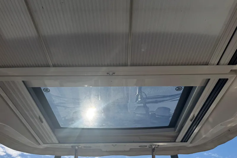  Yacht Photos Pics 2023 Chaparral 347 SSX boat sunroof with sunlight streaming through.