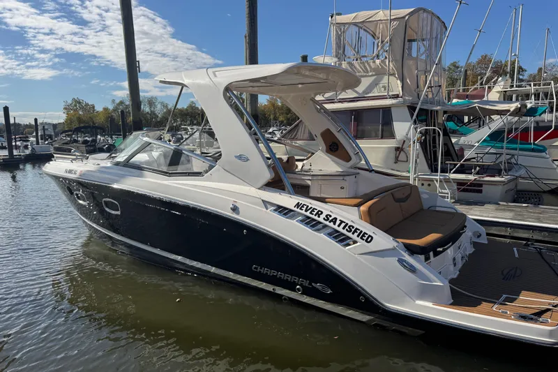  Yacht Photos Pics 2023 Chaparral 347 SSX boat docked at marina under clear sky.