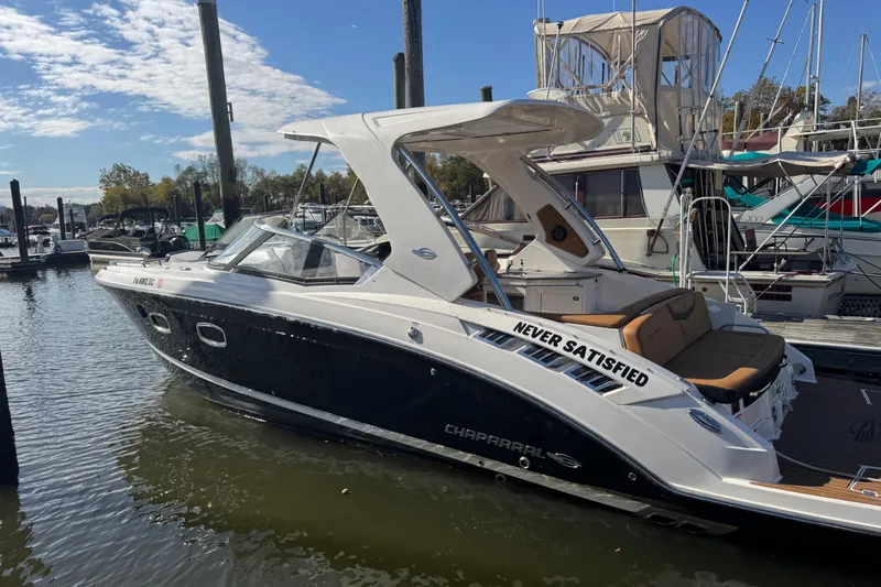 Yacht Photos Pics 2023 Chaparral 347 SSX boat docked at marina under clear sky.