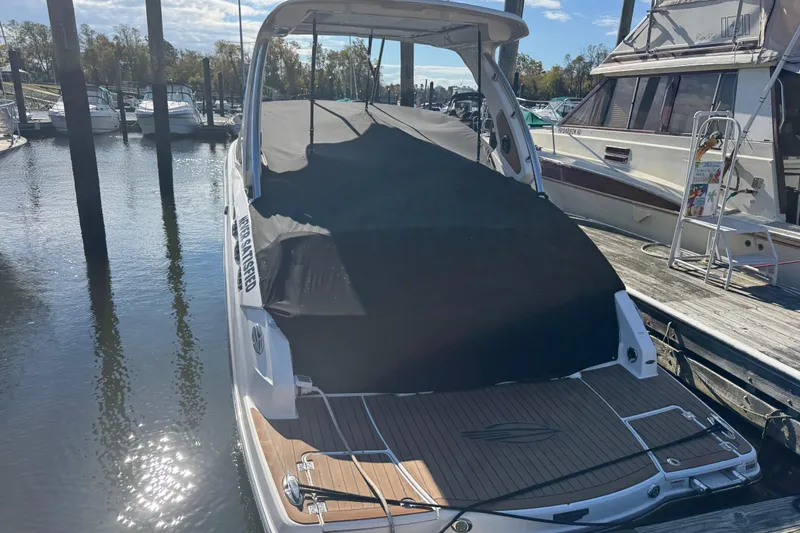  Yacht Photos Pics 2023 Chaparral 347 SSX boat docked, covered, and moored at a marina.