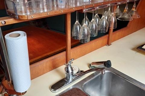 Galley sink with hanging glasses in a 1986 Pearson 36-2 sailboat.