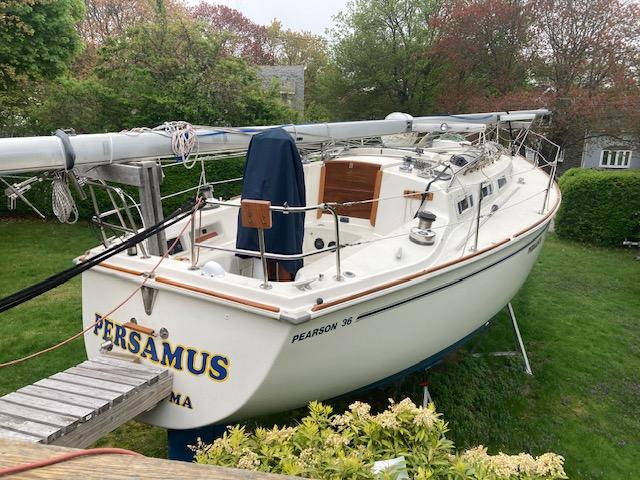 1986 Pearson 36-2 sailboat on land, surrounded by greenery, with visible deck and mast.