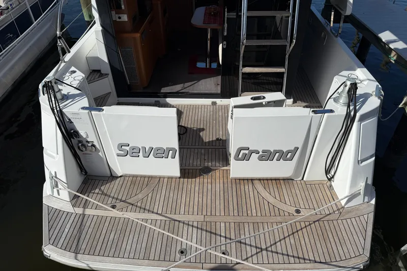 Seven Grand Yacht Photos Pics 2016 Beneteau Swift Trawler 30, rear deck view with "Seven Grand" nameplate.