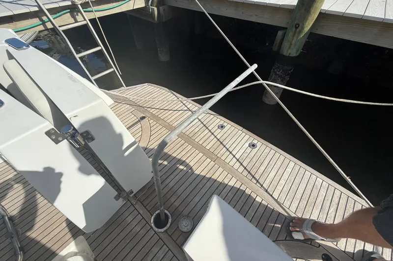 Seven Grand Yacht Photos Pics 2016 Beneteau Swift Trawler 30 docked, showing teak deck and mooring lines.