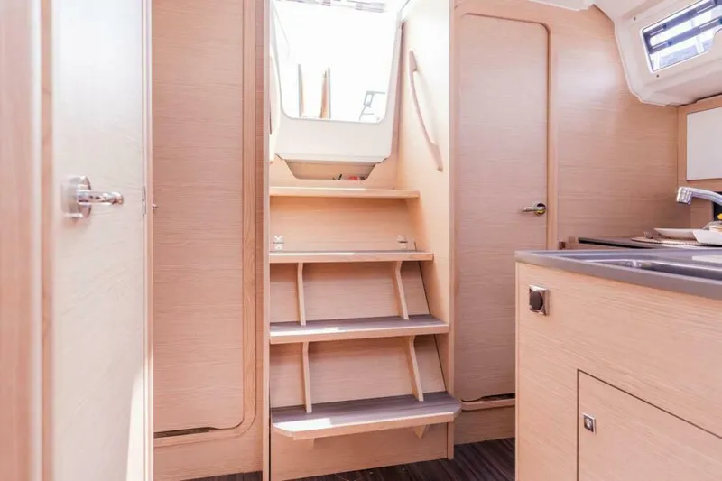In Stock #108 Yacht Photos Pics Interior of 2025 Dufour 37 yacht, featuring wooden stairs and modern cabinetry.