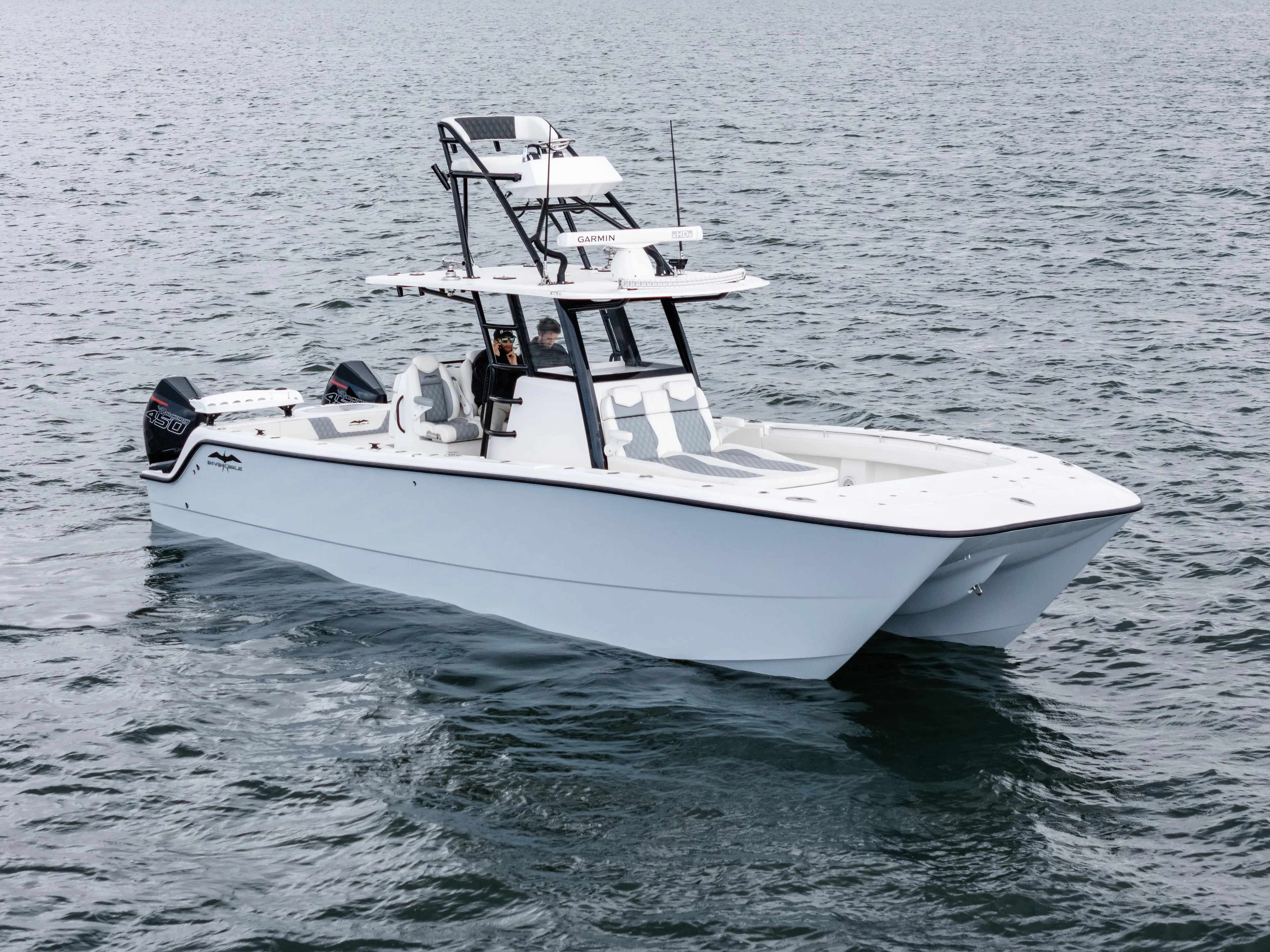 Tuna Colada Yacht Photos Pics 2020 Invincible 35 Catamaran on open water, showcasing sleek design and powerful engines.