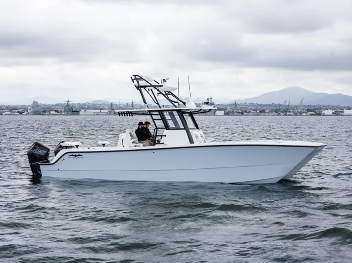 Tuna Colada Yacht Photos Pics 2020 Invincible 35 Catamaran on water, overcast sky, side view.