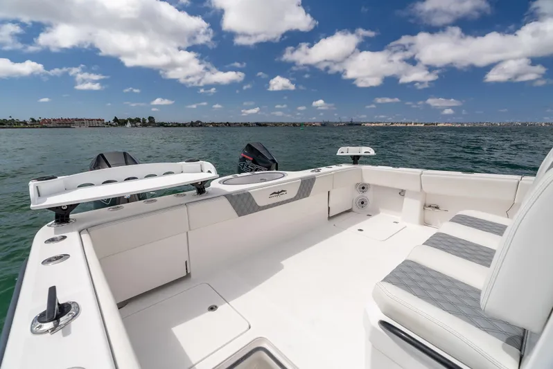 Tuna Colada Yacht Photos Pics 2020 Invincible 35 Catamaran on water, spacious deck, clear sky, and scenic view.