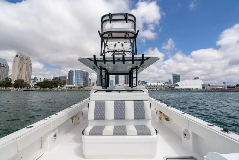 Tuna Colada Yacht Photos Pics 2020 Invincible 35 Catamaran on water, city skyline in background.