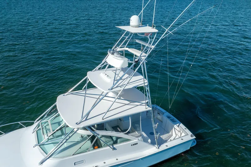 Reel Steel Yacht Photos Pics 2004 Cabo 35 Express boat with tower on blue ocean water.