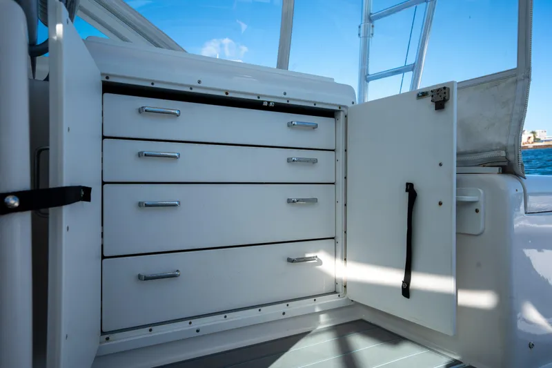 Reel Steel Yacht Photos Pics 2004 Cabo 35 Express boat interior with open storage cabinet and drawers.