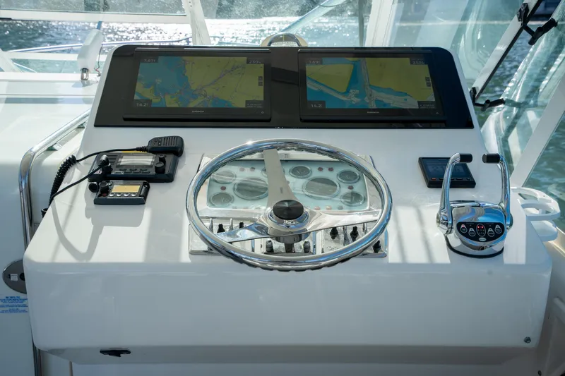 Reel Steel Yacht Photos Pics Helm of 2004 Cabo 35 Express boat with navigation screens and controls.