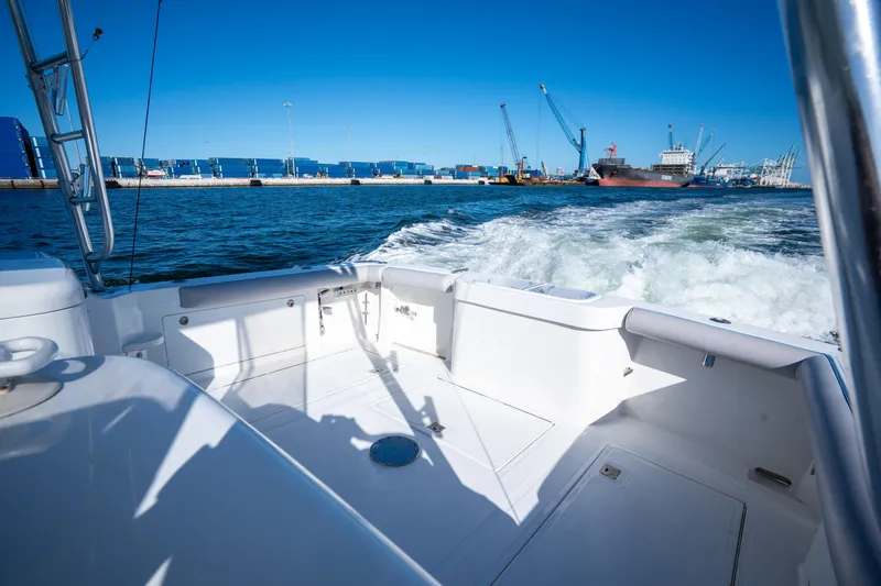 Reel Steel Yacht Photos Pics 2004 Cabo 35 Express boat cruising near industrial port with cranes and containers.