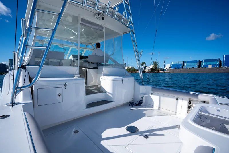 Reel Steel Yacht Photos Pics 2004 Cabo 35 Express boat on water, clear sky, modern design, spacious deck.