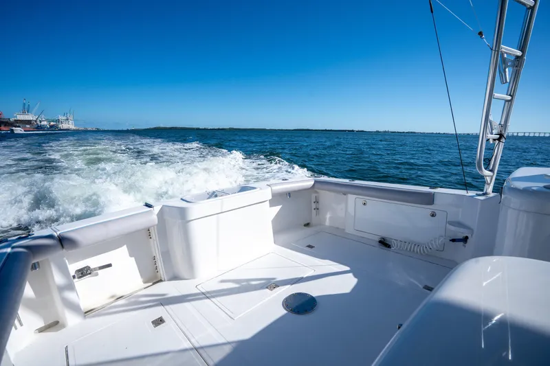Reel Steel Yacht Photos Pics 2004 Cabo 35 Express boat cruising on open water under clear blue sky.