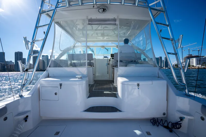 Reel Steel Yacht Photos Pics 2004 Cabo 35 Express yacht with city skyline and blue sky background.