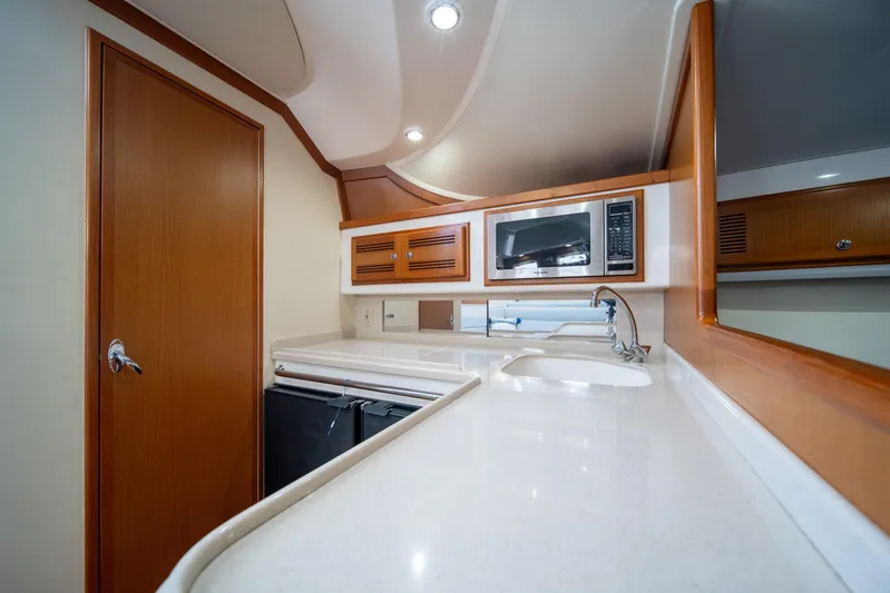 Reel Steel Yacht Photos Pics 2004 Cabo 35 Express yacht interior kitchen with microwave and sink.