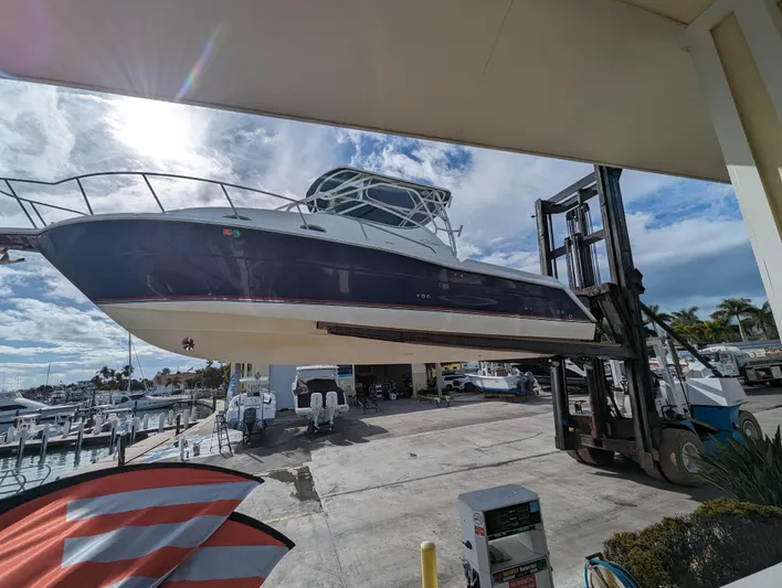 Boatanicals Yacht Photos Pics 2016 Stamas Aegean boat lifted at marina, sunny day, clear sky.