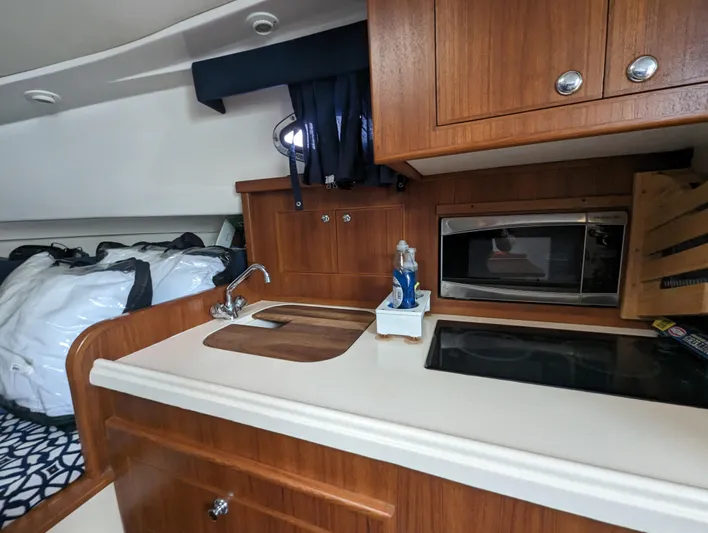 Boatanicals Yacht Photos Pics 2016 Stamas Aegean boat interior with kitchenette, sink, and microwave.