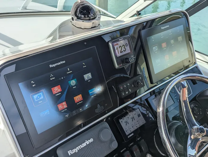 Boatanicals Yacht Photos Pics Stamas Aegean 2016 boat dashboard with Raymarine navigation displays and compass.