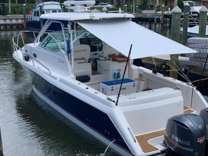 Boatanicals Yacht Photos Pics 2016 Stamas Aegean boat docked, featuring Yamaha engines and a shaded deck area.