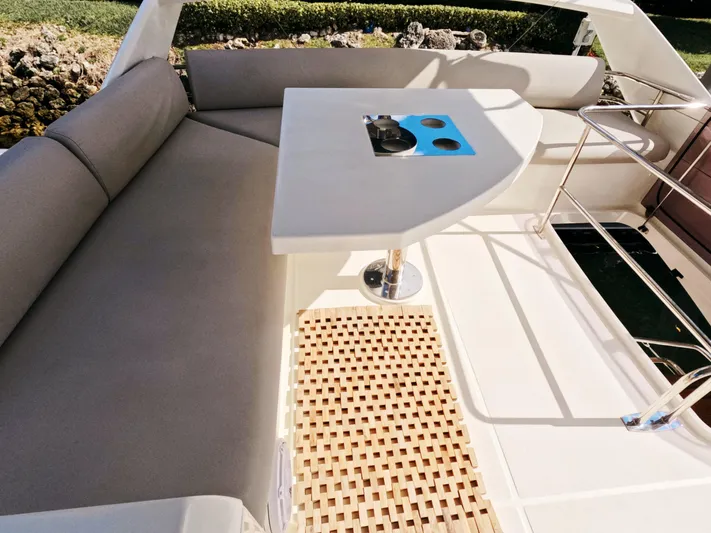  Yacht Photos Pics Prestige 460 yacht 2020 model, featuring a sleek outdoor seating area with table.