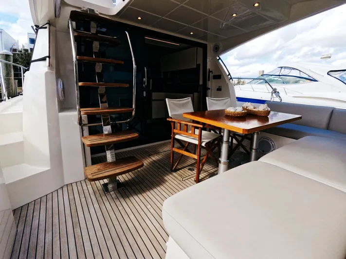  Yacht Photos Pics Prestige 460 yacht interior, 2020 model, featuring elegant seating and wooden table.