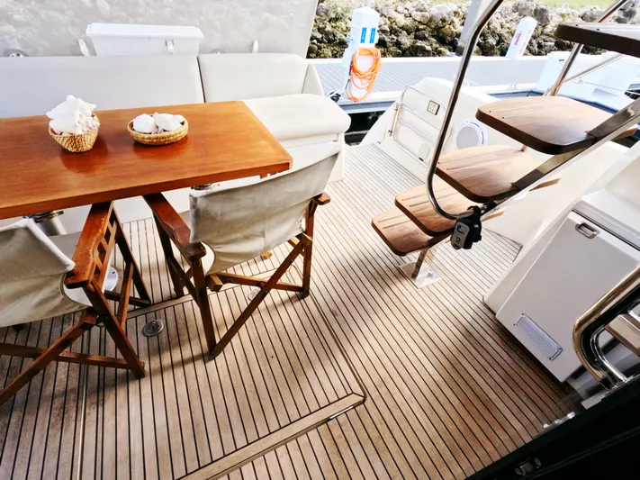  Yacht Photos Pics Prestige 460 yacht deck with wooden table, chairs, and stairs, 2020 model.